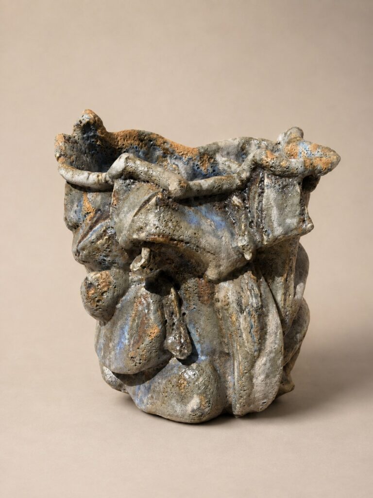 Rumpled vessel in blue and rust glaze. Ceramic sculpture by Ted Fullwood